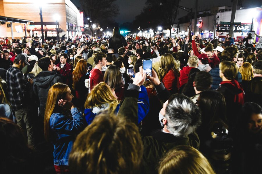 Alabama fans celebrate in the street in Tuscaloosa, Ala., Monday night, Jan. 11, 2021, after Alabama defeated Ohio State 52-24 in the NCAA college football national championship game in Miami Gardens, Fla. (Benjamin Flanagan/Alabama Media Group via AP)