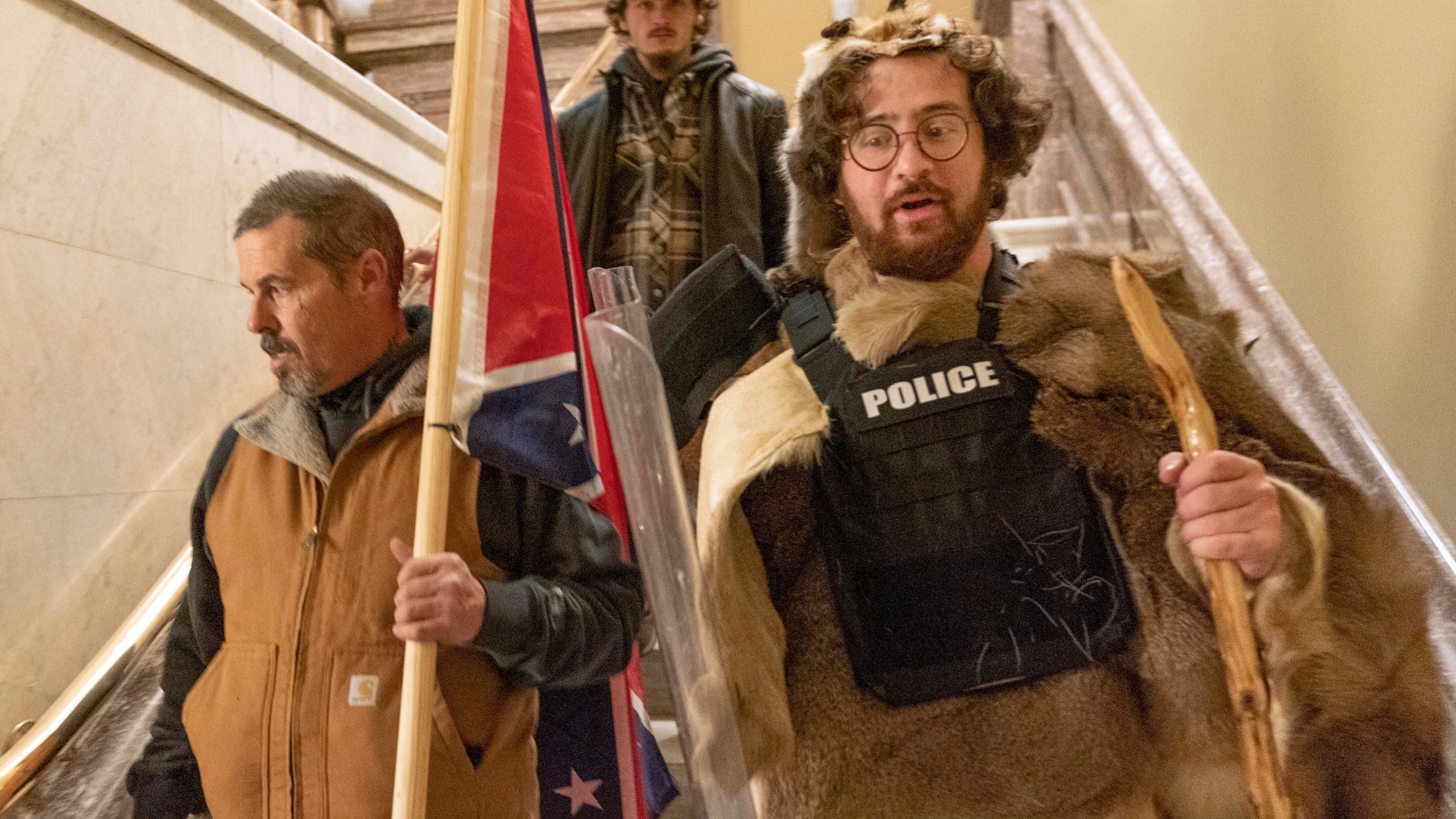 Supporters of President Donald Trump, including Aaron Mostofsky, right, who is identified in his arrest warrant, walk down the stairs outside the Senate Chamber in the U.S. Capitol on Jan. 6, 2021. (Manuel Balce Ceneta / Associated Press)