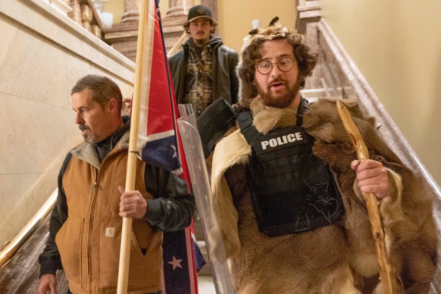 Supporters of President Donald Trump, including Aaron Mostofsky, right, who is identified in his arrest warrant, walk down the stairs outside the Senate Chamber in the U.S. Capitol on Jan. 6, 2021. (Manuel Balce Ceneta / Associated Press)