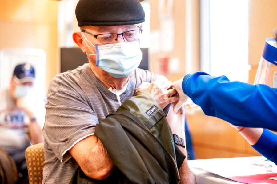 Jim Clark, 86, receives a first dose of Pfizer-BioNTech COVID-19 vaccine from UC Davis Health on Jan. 12, 2021, in Sacramento, Calif. (AP Photo/Noah Berger, Pool)