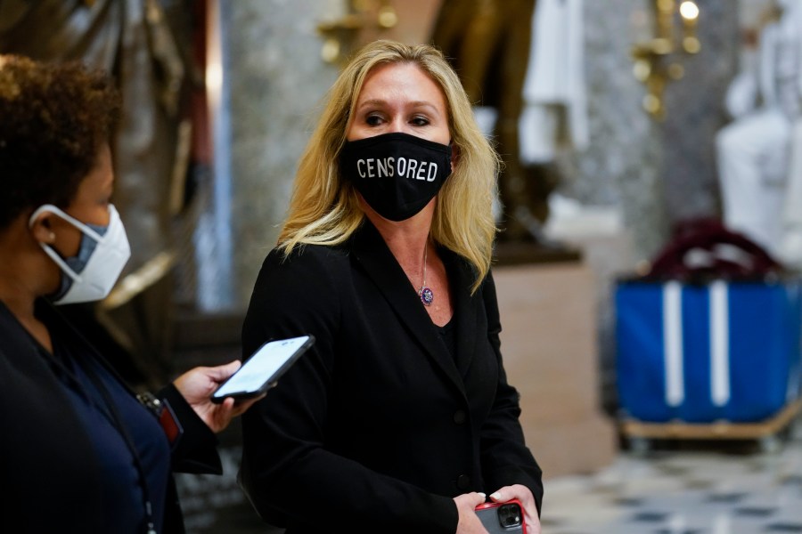 Rep. Marjorie Taylor Greene, R-Ga., walks on Capitol Hill in Washington, Wednesday, Jan. 13, 2021. (AP Photo/Susan Walsh)