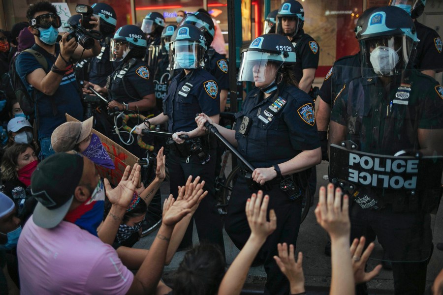 FILE - This May 31, 2020 file photo shows New York City Police facing off with activists during a protest march in the Bedford-Stuyvesant section of the Brooklyn borough of New York. New York’s attorney general sued the New York Police Department on Thursday, Jan. 14, 2021 alleging the rough treatment of protesters last spring in the wake of George Floyd’s killing was part of a longstanding pattern of abuse that stemmed from inadequate training, supervision and discipline. (AP Photo/Kevin Hagen, FIle)