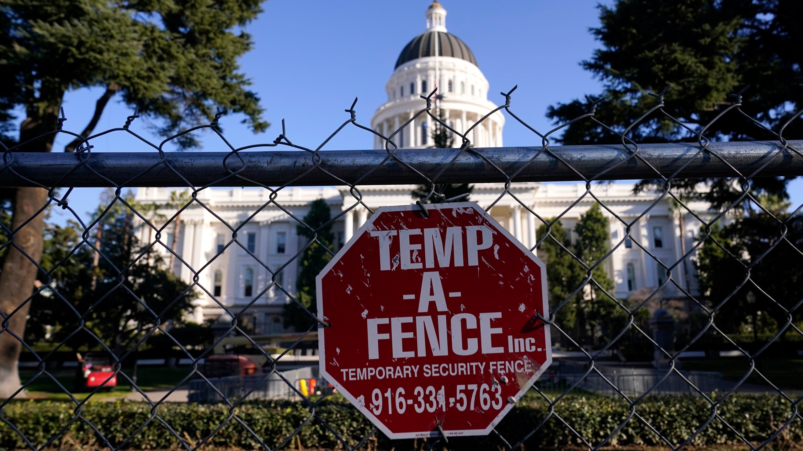 A temporary six-foot high chain link fence surrounds the state Capitol because of concerns over the potential for civil unrest, in Sacramento on Jan. 14, 2021. (AP Photo/Rich Pedroncelli)