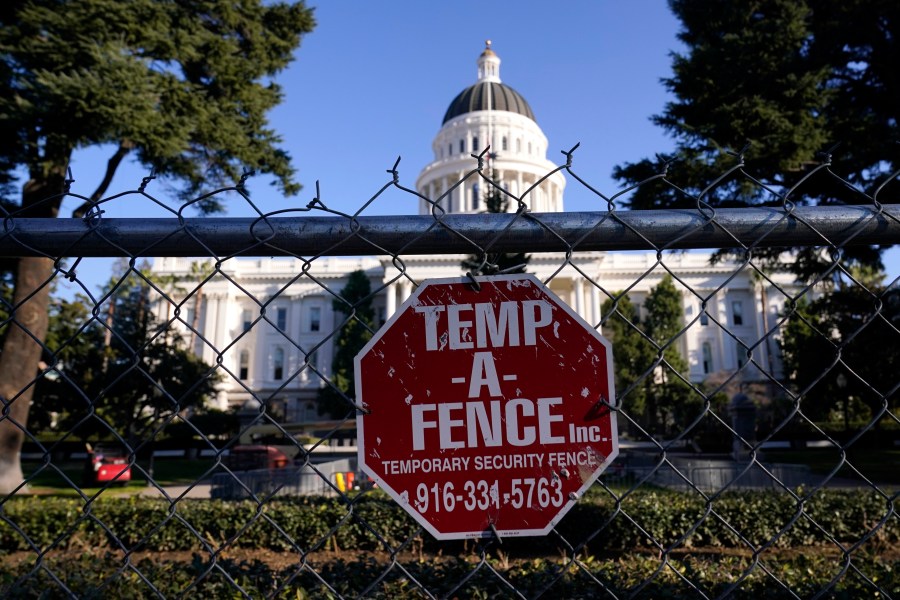 A temporary six-foot high chain link fence surrounds the state Capitol because of concerns over the potential for civil unrest, in Sacramento on Jan. 14, 2021. (AP Photo/Rich Pedroncelli)