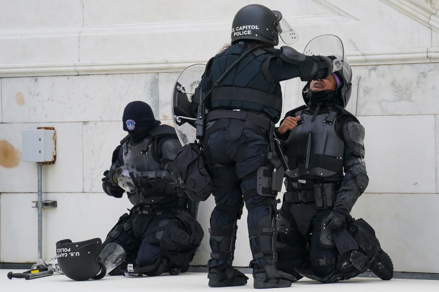 A police officer has eyes flushed with water after a confrontation with rioters at the Capitol in Washington on Jan. 6, 2021. (AP Photo/John Minchillo)