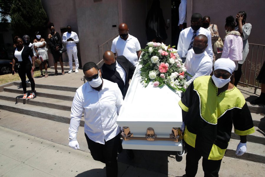 In this July 21, 2020, file photo, pall bearers carry a casket with the body of Lydia Nunez, who died from COVID-19, after a funeral service at the Metropolitan Baptist Church in Los Angeles. (AP Photo/Marcio Jose Sanchez, File)