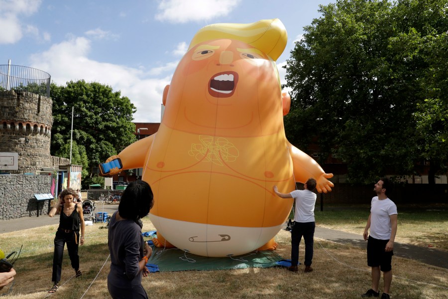 In this file photo taken Tuesday, July 10, 2018, a six-meter high cartoon baby blimp depicting U.S. President Donald Trump in north London. (AP Photo/Matt Dunham, FILE)