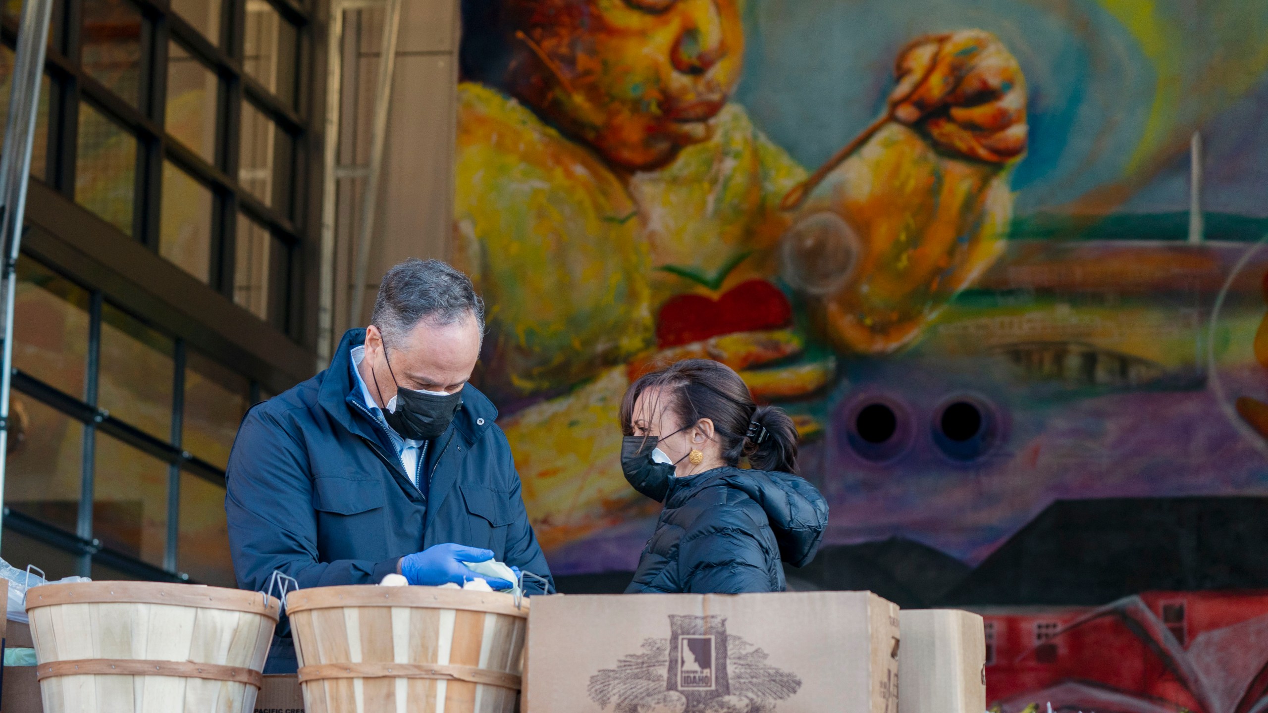 Vice President-elect Kamala Harris, right, and her husband Douglas Emhoff, pack grocery bags for those in need of food while volunteering during the National Day of Service, Monday, Jan. 18, 2021, at Martha's Table in the southeast neighborhood of Washington. (AP Photo/Jacquelyn Martin)