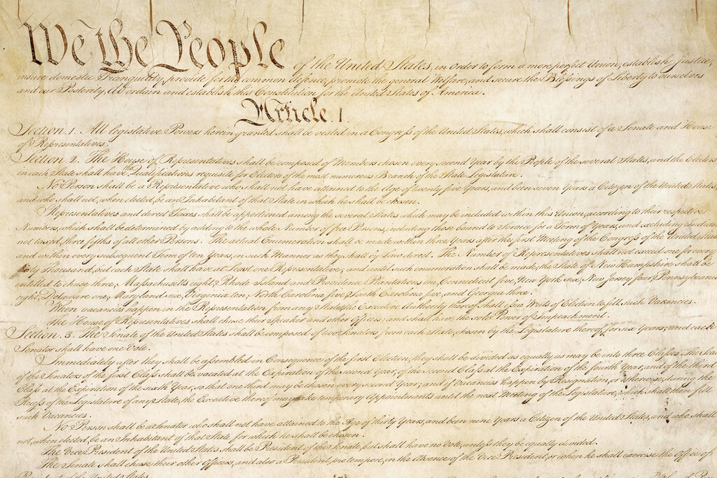 This photo made available by the U.S. National Archives shows a portion of the first page of the United States Constitution. (National Archives via AP)