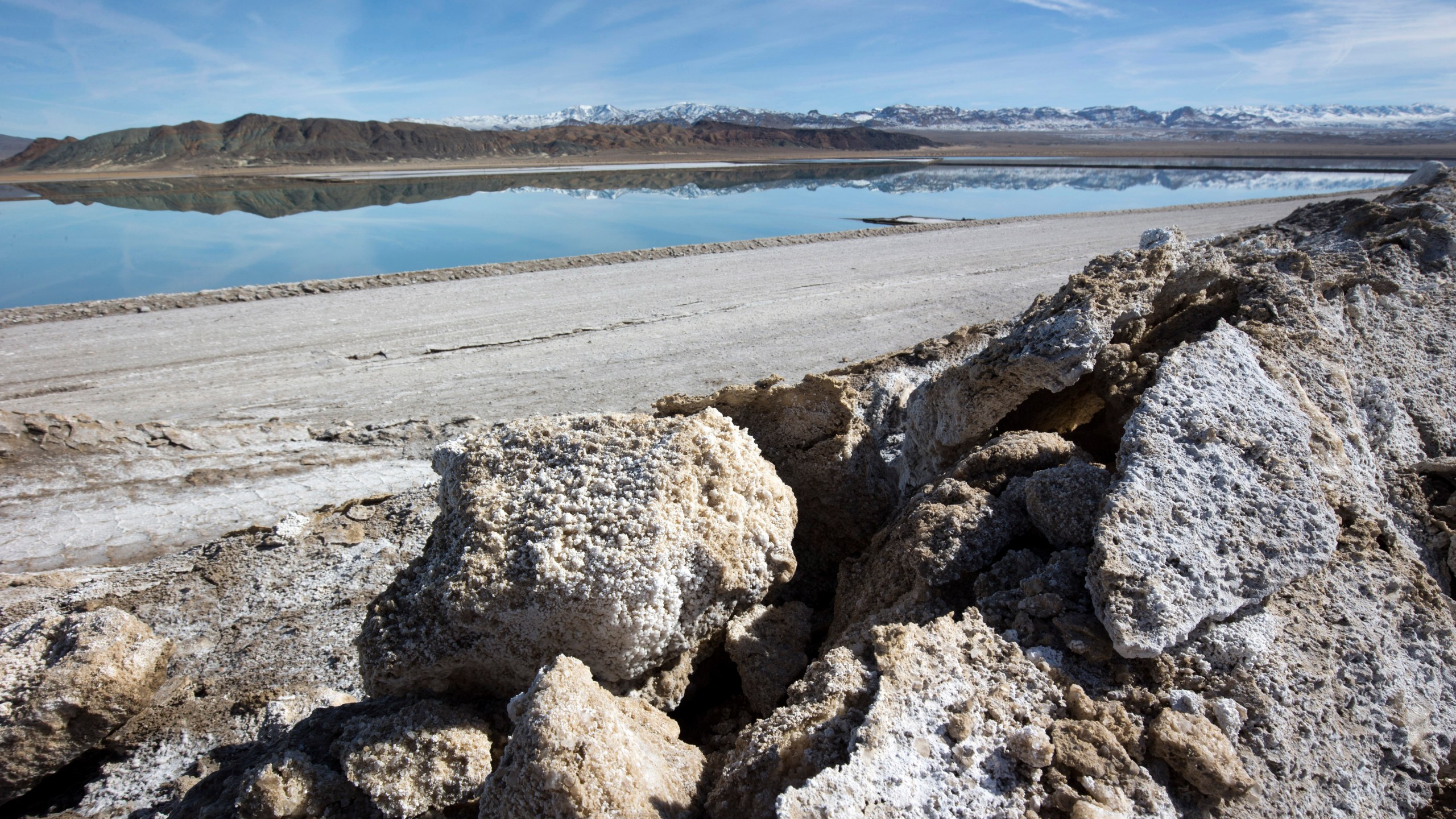 In this Jan. 30, 2017, file photo, waste salt, foreground, is shown near an evaporation pond at the Silver Peak lithium mine near Tonopah, Nev. (Steve Marcus/Las Vegas Sun via AP)