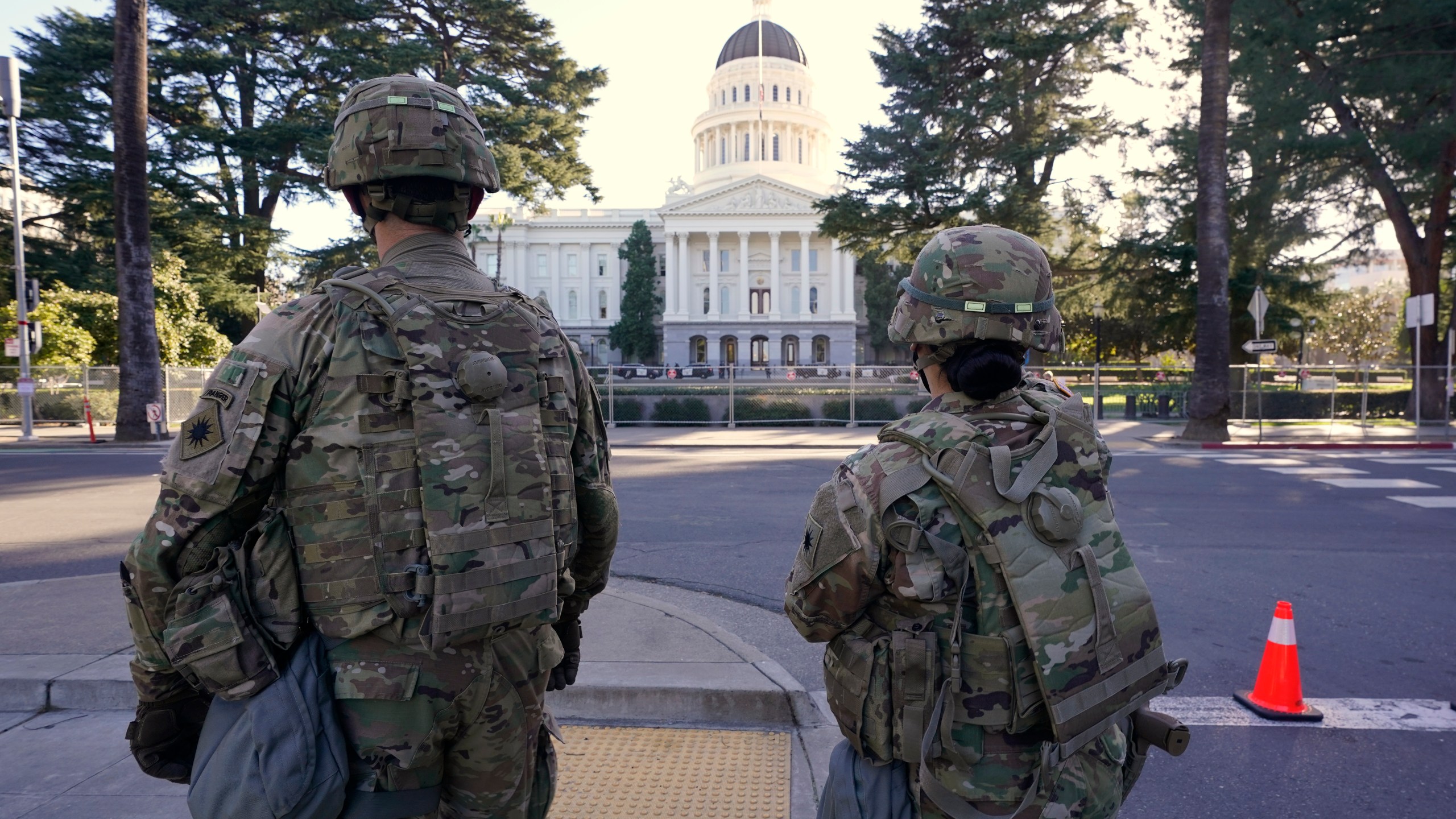 Members of the California National Guard walk past the state Capitol in Sacramento, on Jan. 20, 2021. (AP Photo/Rich Pedroncelli)