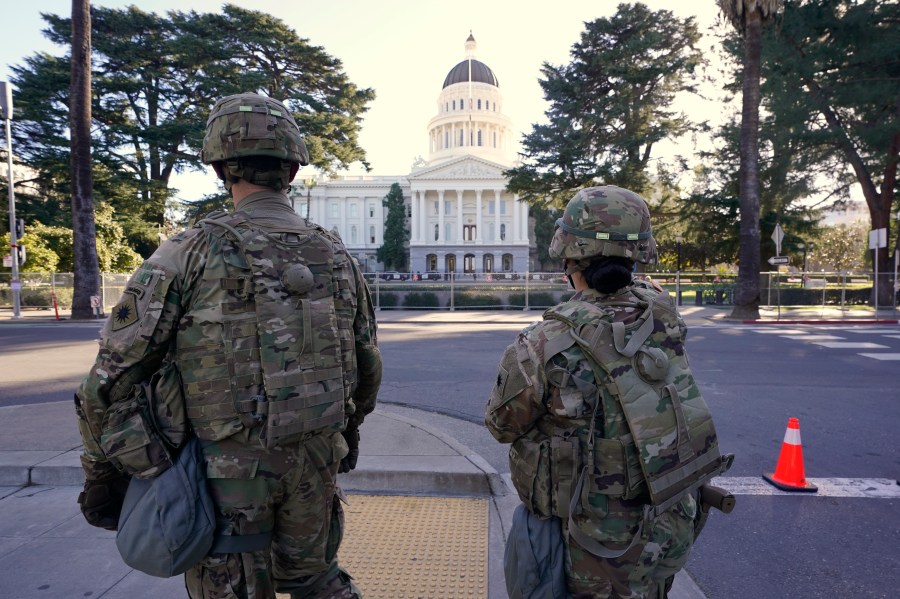 Members of the California National Guard walk past the state Capitol in Sacramento, on Jan. 20, 2021. (AP Photo/Rich Pedroncelli)