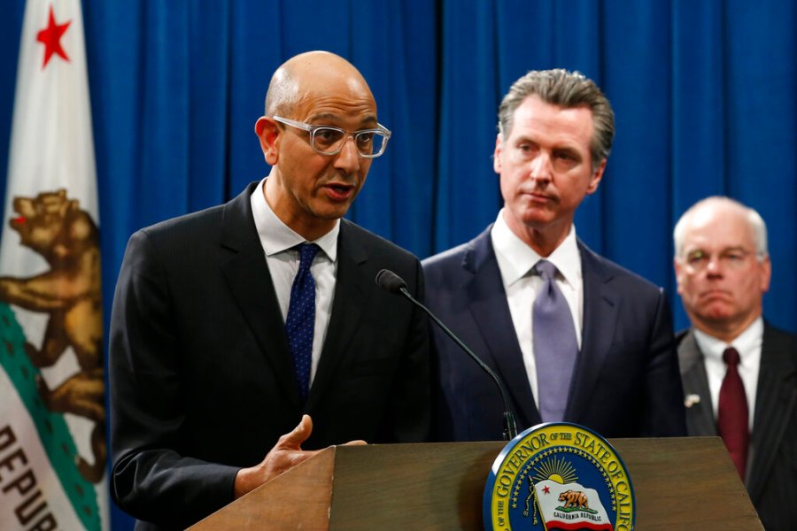 In this March 12, 2020, file photo Dr. Mark Ghaly, secretary of the California Health and Human Services, discusses the coronavirus as Gov. Gavin Newsom, center, listens at a news conference in Sacramento, Calif. (AP Photo/Rich Pedroncelli, File)