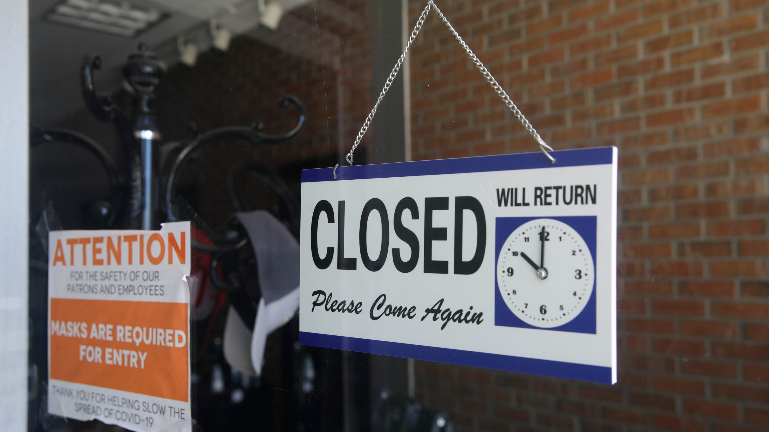 In this July 18, 2020, file photo a closed sign hangs in the window of a barber shop in Burbank, Calif. (AP Photo/Marcio Jose Sanchez)In this July 18, 2020, file photo a closed sign hangs in the window of a barber shop in Burbank, Calif. (AP Photo/Marcio Jose Sanchez)