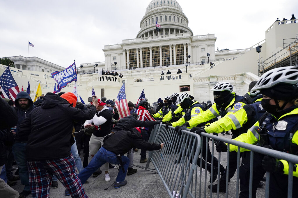 In this Jan. 6, 2021 file photo, Trump supporters try to break through a police barrier at the Capitol in Washington. (AP Photo/Julio Cortez, File)