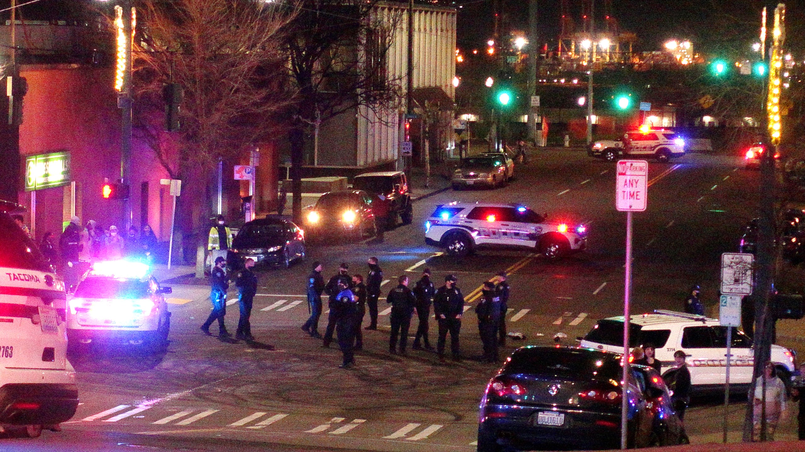 Tacoma Police and other law enforcement officers stand in an intersection near the site of a car crash Saturday, Jan. 23, 2021, in downtown Tacoma, Wash. (AP Photo/Ted S. Warren)Tacoma Police and other law enforcement officers stand in an intersection near the site of a car crash Saturday, Jan. 23, 2021, in downtown Tacoma, Wash. (AP Photo/Ted S. Warren)