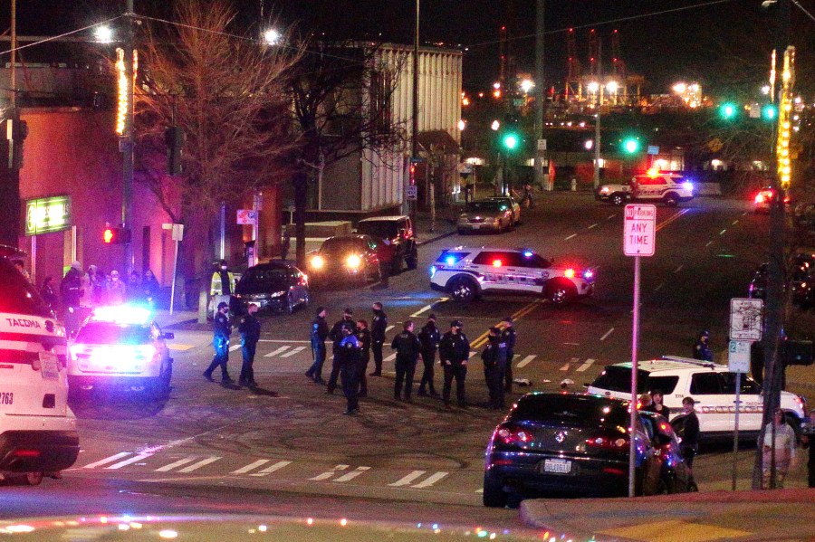 Tacoma Police and other law enforcement officers stand in an intersection near the site of a car crash Saturday, Jan. 23, 2021, in downtown Tacoma, Wash. (AP Photo/Ted S. Warren)Tacoma Police and other law enforcement officers stand in an intersection near the site of a car crash Saturday, Jan. 23, 2021, in downtown Tacoma, Wash. (AP Photo/Ted S. Warren)