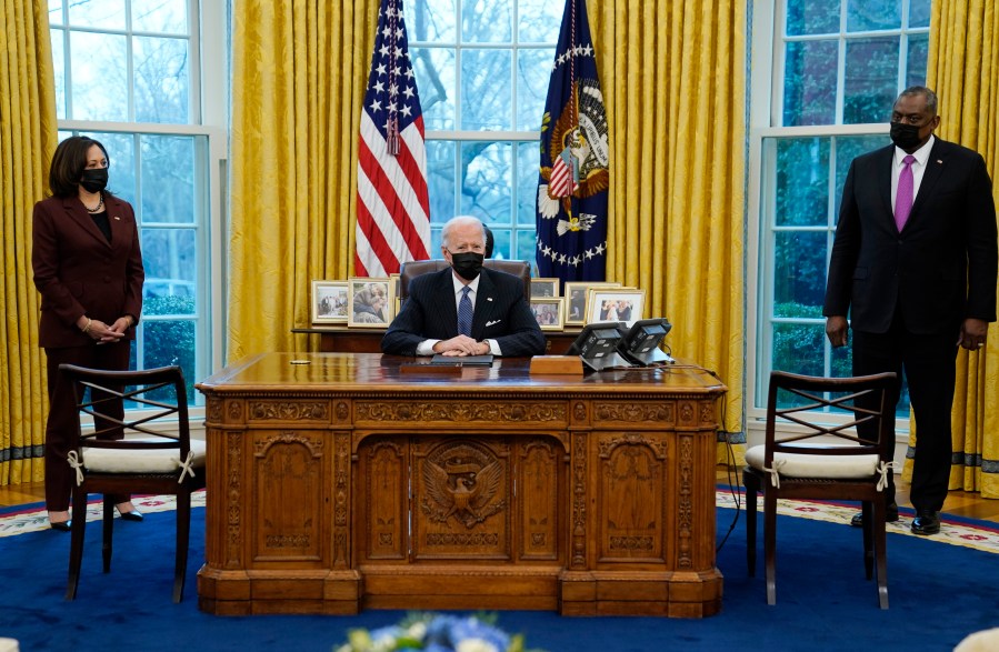 President Joe Biden meets with Secretary of Defense Lloyd Austin, Vice President Kamala Harris, in the Oval Office of the White House, Monday, Jan. 25, 2021, in Washington. (AP Photo/Evan Vucci)