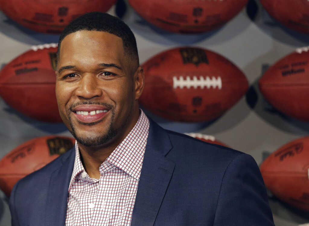 In this Thursday, Nov. 30, 2017 file photo, Former New York Giant Michael Strahan poses for a picture at the opening of "NFL Experience" in Times Square, New York. (AP Photo/Seth Wenig, File)