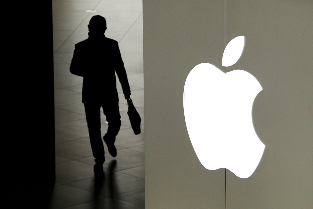 In this Jan. 3, 2019, file photo, a man leaves an Apple store in Beijing. Apple says it will roll out a new privacy control in spring 2021 to prevent iPhone apps from secretly shadowing people. (AP Photo/Andy Wong, File)