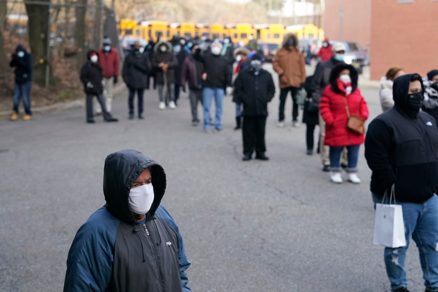 People wait in line for the COVID-19 vaccine in Paterson, N.J., Thursday, Jan. 21, 2021. (AP Photo/Seth Wenig)