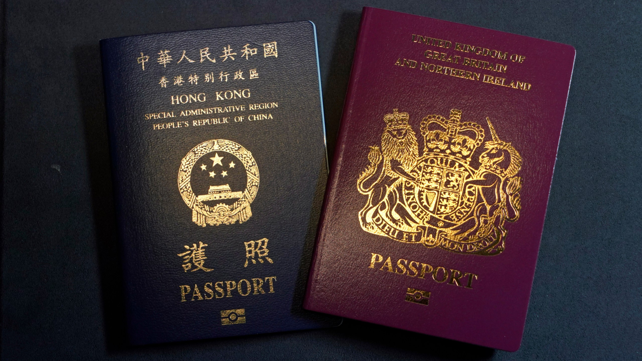 A British National Overseas passports (BNO) and a Hong Kong Special Administrative Region of the People's Republic of China passport are pictured in Hong Kong, Friday, Jan. 29, 2021. (AP Photo/Kin Cheung)