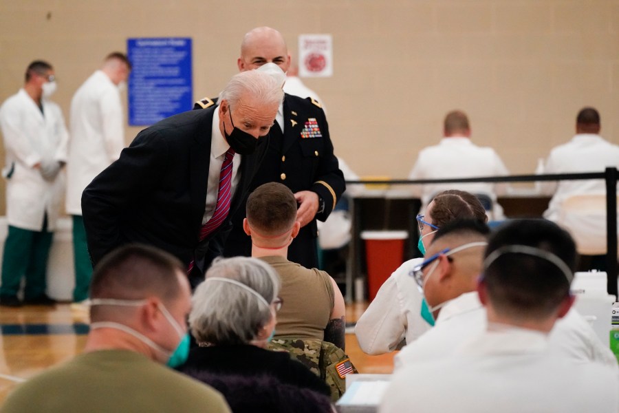 President Joe Biden speaks with a service member as he tours the COVID-19 vaccine center at Walter Reed National Military Medical Center with Col. Andrew Barr, director of Walter Reed on Jan. 29, 2021. (Alex Brandon/Associated Press)