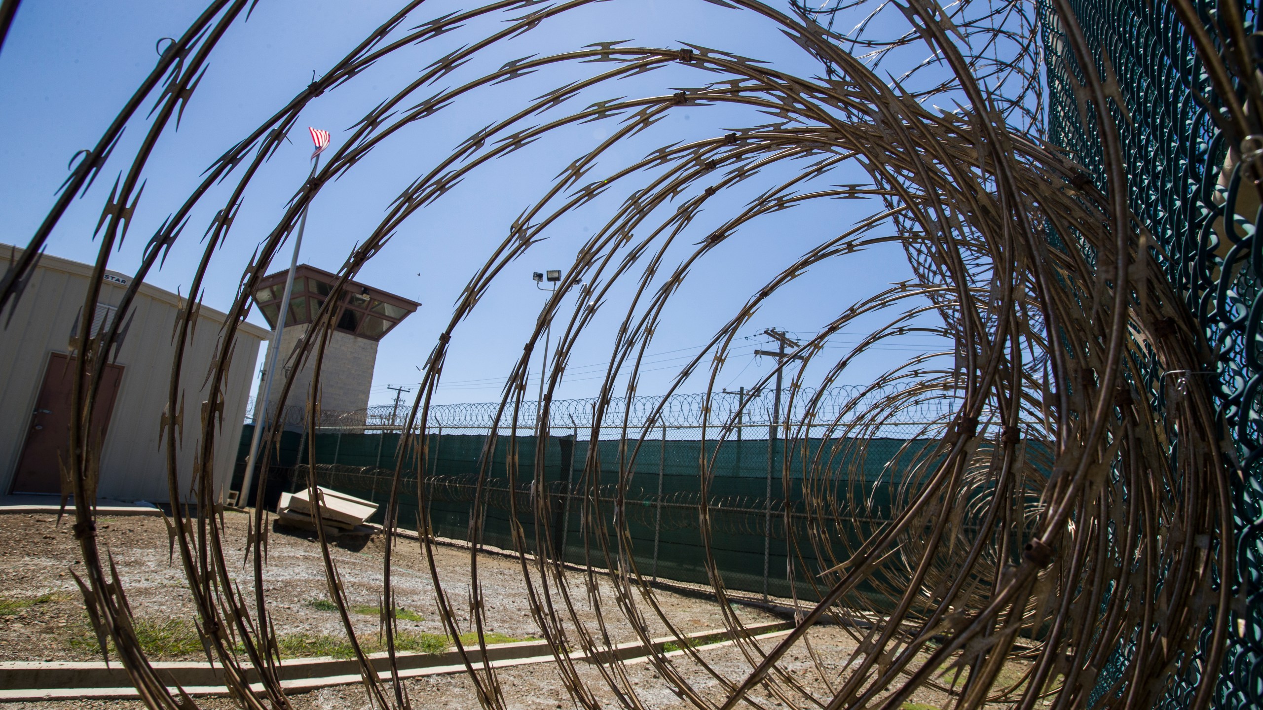 In this Wednesday, April 17, 2019 file photo reviewed by U.S. military officials, the control tower is seen through the razor wire inside the Camp VI detention facility in Guantanamo Bay Naval Base, Cuba. (AP Photo/Alex Brandon)