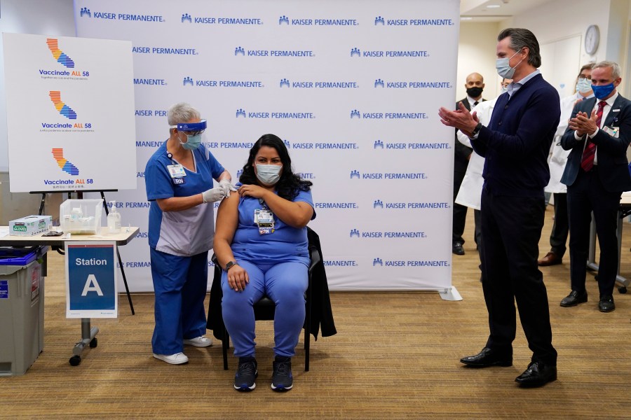 Gov. Gavin Newsom watches as ICU nurse Helen Cordova receives the Pfizer-BioNTech COVID-19 vaccine at Kaiser Permanente Los Angeles Medical Center on Dec. 14, 2020. (Jae C. Hong-Pool/Getty Images)