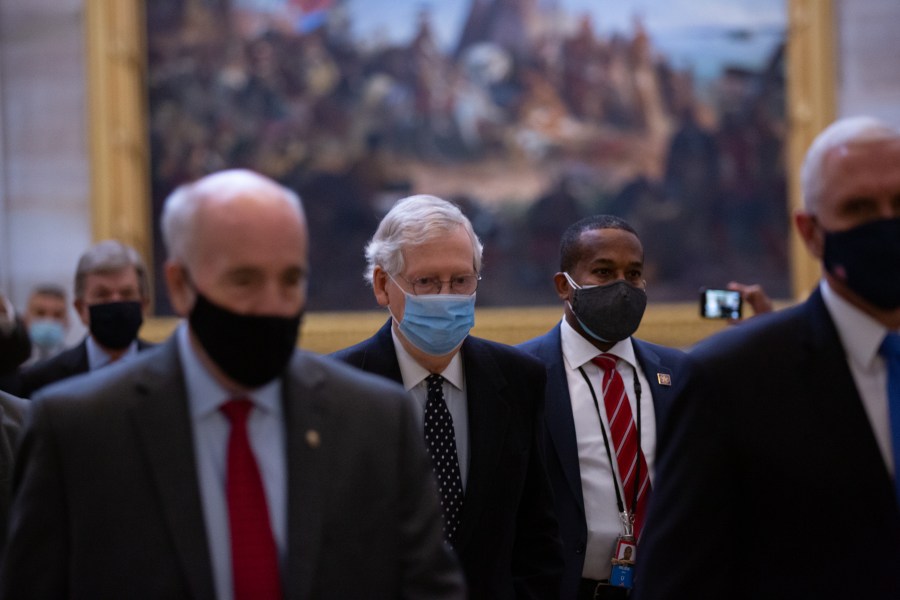 Senate Majority Leader Mitch McConnell, center, walks through the Rotunda headed to the House Chamber at the U.S. Capitol on Jan. 6, 2021. (Cheriss May / Getty Images)