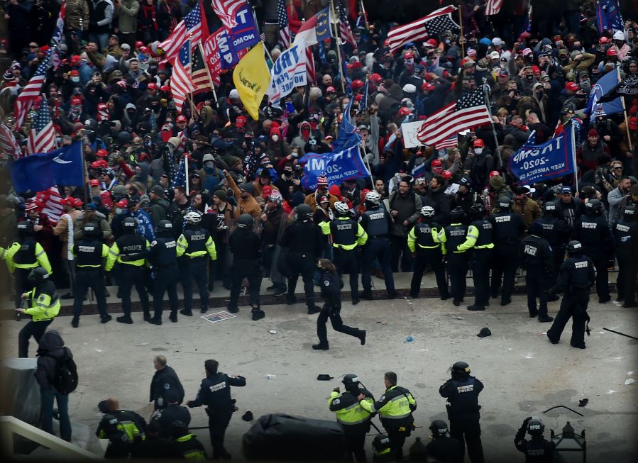 Police hold back supporters of US President Donald Trump as they gather outside the US Capitol's Rotunda on January 6, 2021, in Washington, DC. (OLIVIER DOULIERY/AFP via Getty Images)