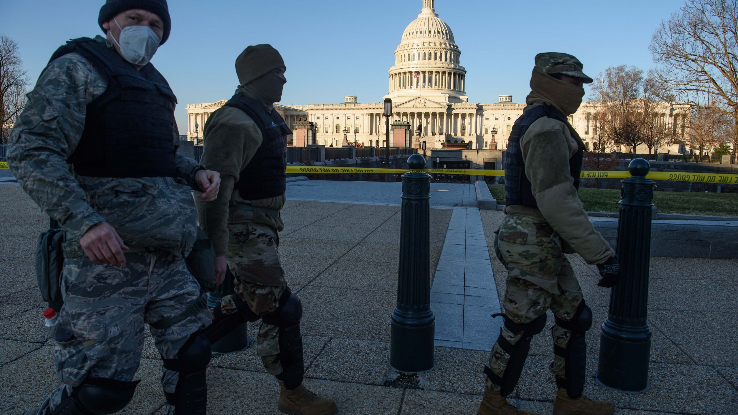 Members of the D.C. National Guard walk past the U.S. Capitol in Washington, D.C., on Jan. 7, 2020, one day after supporters of outgoing President Donald Trump stormed the building. (NICHOLAS KAMM/AFP via Getty Images)