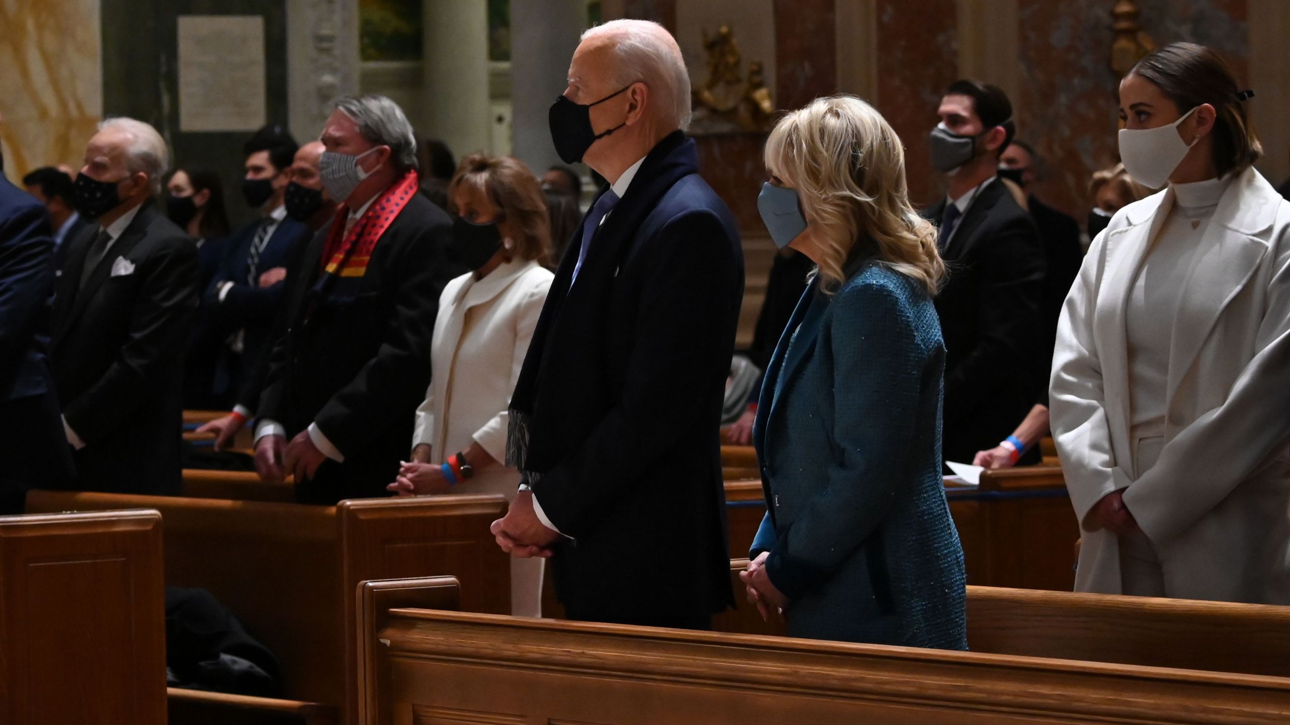 US President-elect Joe Biden (CL) and incoming First Lady Jill Biden attend Mass at the Cathedral of St. Matthew the Apostle in Washington, DC, on January 20, 2021. (JIM WATSON/AFP via Getty Images)