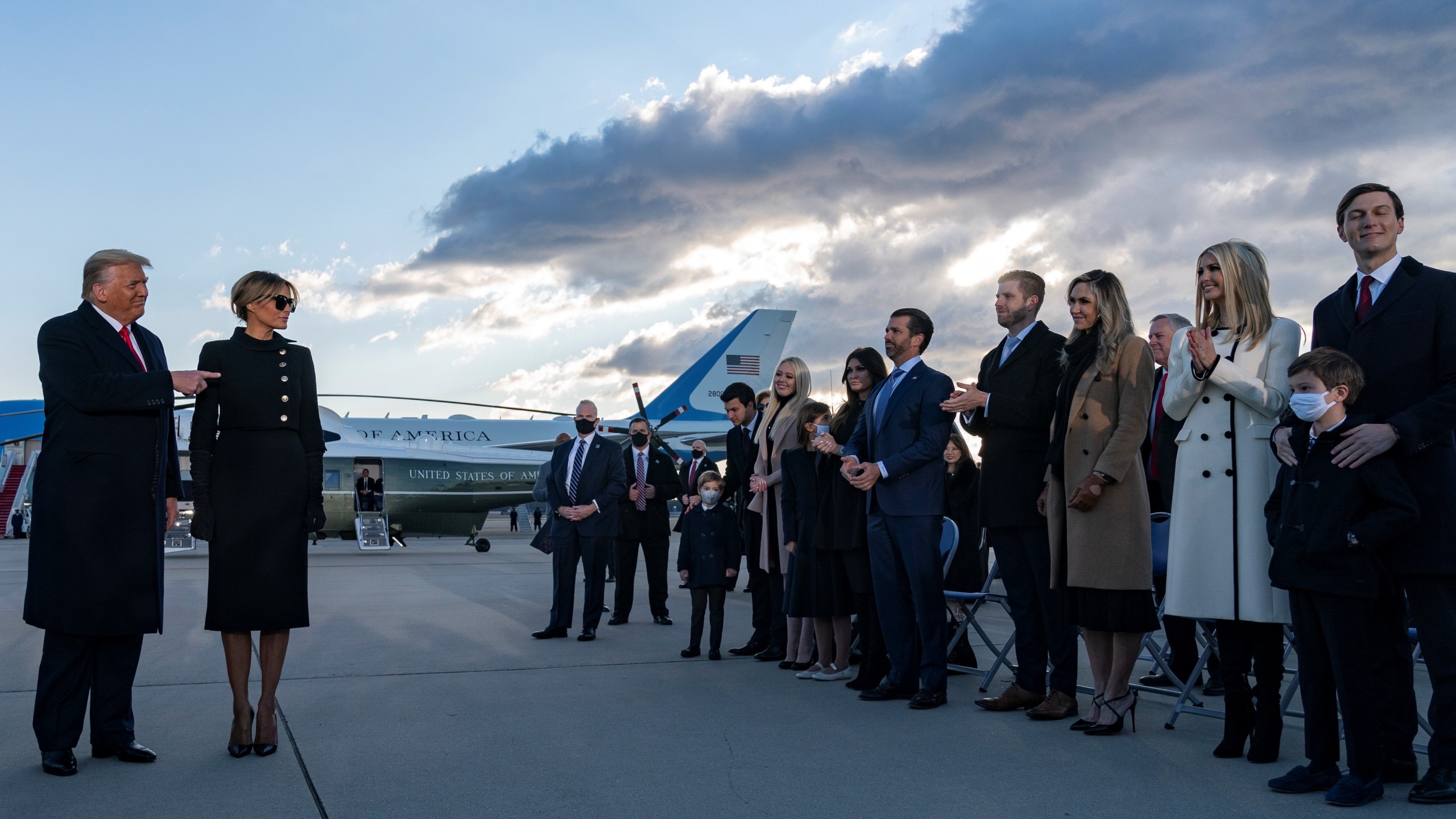 President Donald Trump and first lady Melania Trump meet Ivanka Trump (second from right), husband Jared Kushner (right), their children, Eric and Donald Jr. (both center-right) and Trump family members stand on the tarmac at Joint Base Andrews in Maryland as the outgoing president departs on Jan. 20, 2021. (Alex Edelman / AFP / Getty Images)