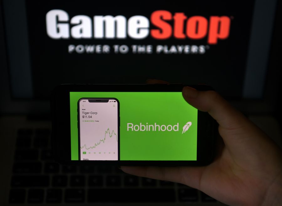 This photo illustration shows the logos of video grame retail store GameStop and trading application Robinhood in a computer and on a mobile phone in Arlington, Virginia on Jan. 28, 2021. An epic battle is unfolding on Wall Street, with a cast of characters clashing over the fate of GameStop, a struggling chain of video game retail stores. The conflict has sent GameStop on a stomach-churning ride with amateur investors taking on the financial establishment in the mindset of the Occupy Wall Street movement launched a decade ago. (Olivier DOULIERY / AFP via Getty Images)