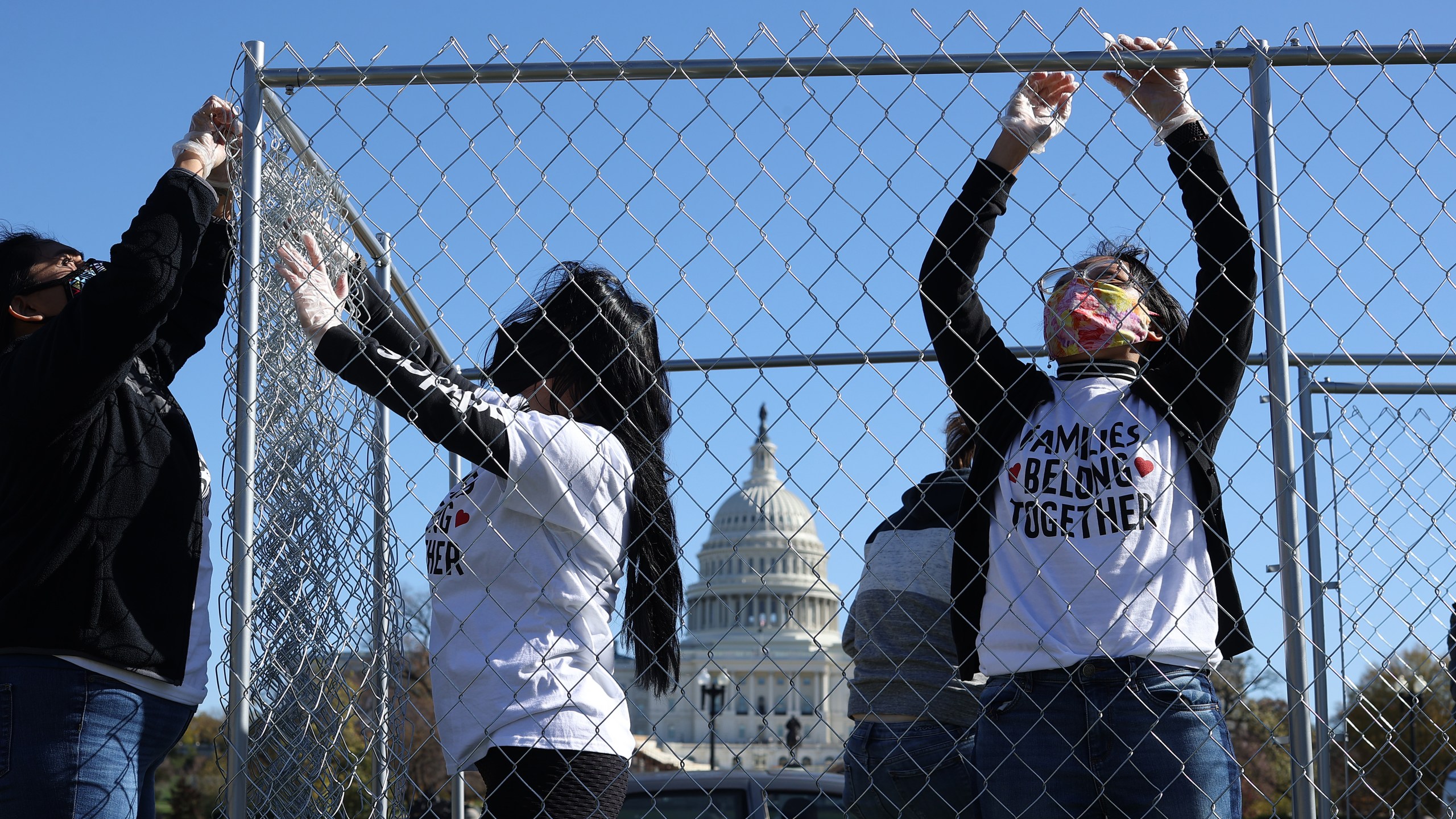 Volunteers from immigrant advocacy group Families Belong Together build a chainlink cage to fill with about 600 teddy bears "representing the children still separated as a result of U.S. immigration policies" on the National Mall Nov. 16, 2020 in Washington, D.C. (Chip Somodevilla/Getty Images)