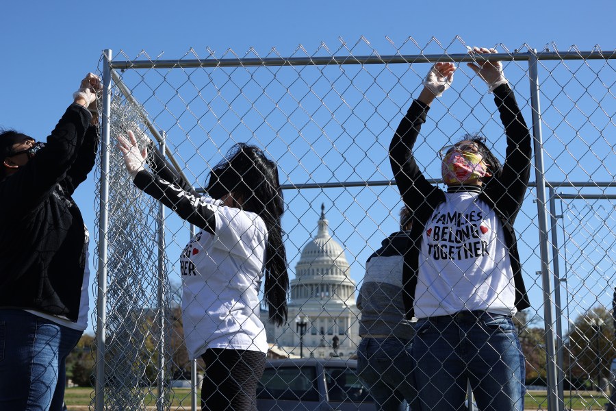 Volunteers from immigrant advocacy group Families Belong Together build a chainlink cage to fill with about 600 teddy bears "representing the children still separated as a result of U.S. immigration policies" on the National Mall Nov. 16, 2020 in Washington, D.C. (Chip Somodevilla/Getty Images)