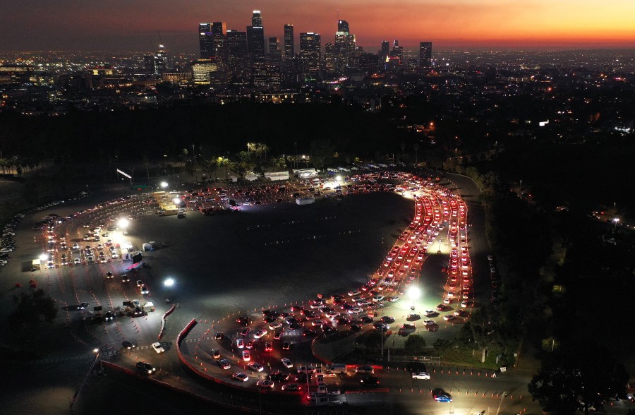 In an aerial view from a drone, cars are seen lined up at Dodger Stadium for coronavirus testing as dusk falls over downtown Los Angeles on Dec. 2, 2020. (Mario Tama/Getty Images)