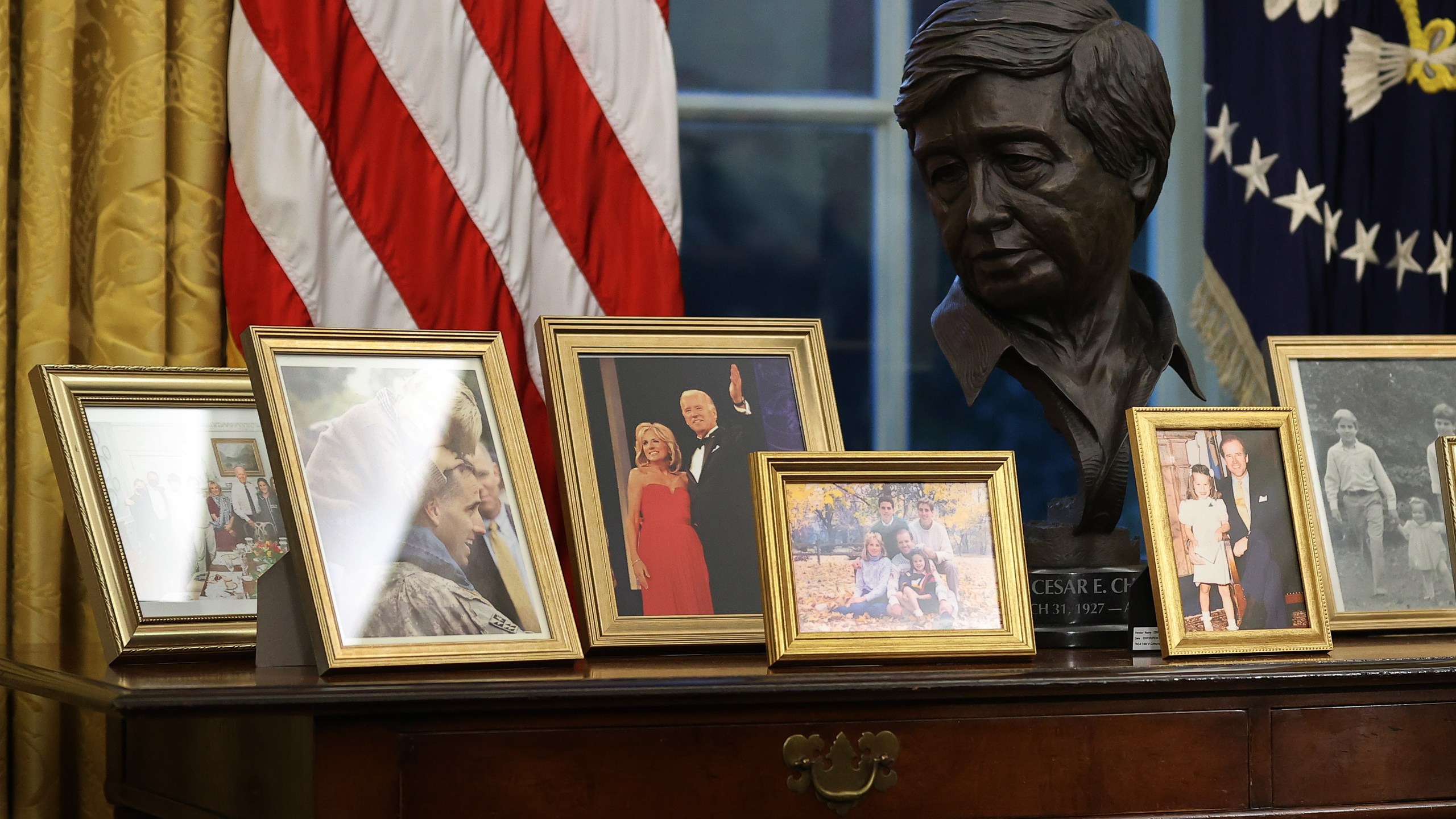 A bust of Cesar Chavez is displayed as President Joe Biden prepares to sign a series of executive orders at the Resolute Desk in the Oval Office just hours after his inauguration on Jan. 20, 2021. (Chip Somodevilla / Getty Images)