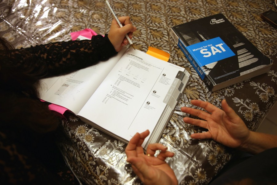 A tutor at The Princeton Review goes over SAT test preparation with an 11th grader on March 6, 2014, in Pembroke Pines, Florida. (Joe Raedle / Getty Images)