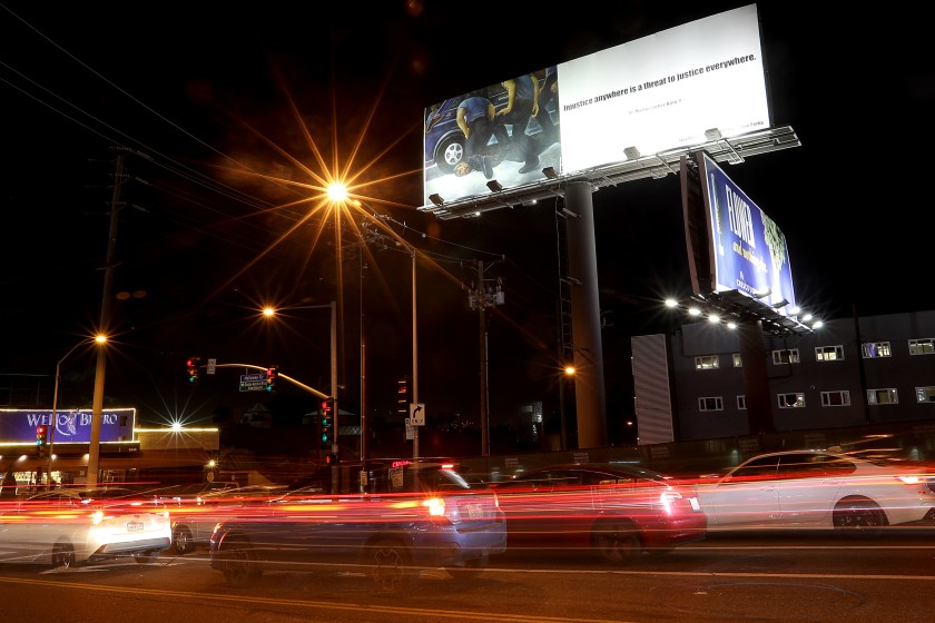 At the intersection of La Cienega Boulevard and Holloway Drive in West Hollywood, a billboard depicts the police killing of George Floyd. (Luis Sinco / Los Angeles Times)