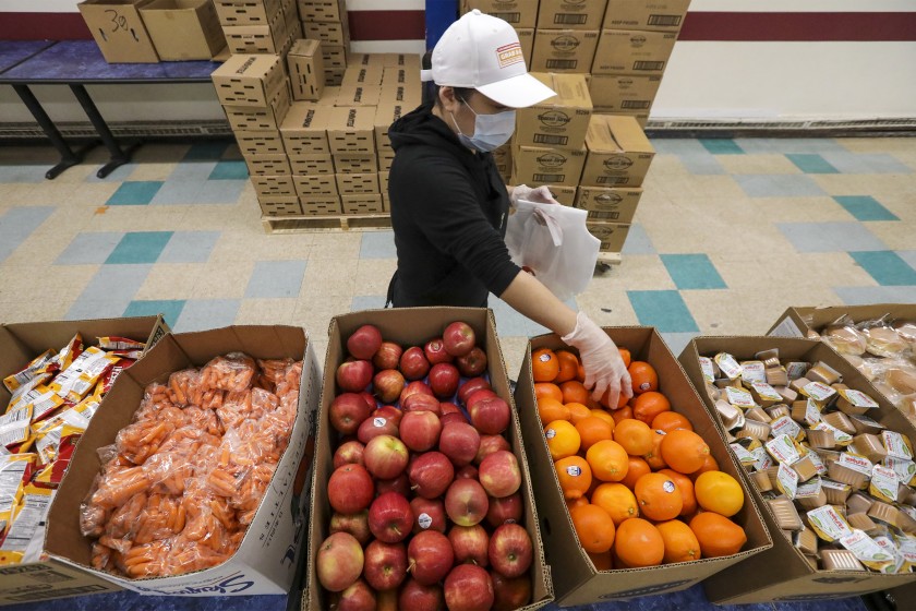 Meal bags are assembled for distribution to families at Garfield High in East Los Angeles. (Irfan Khan / Los Angeles Times)