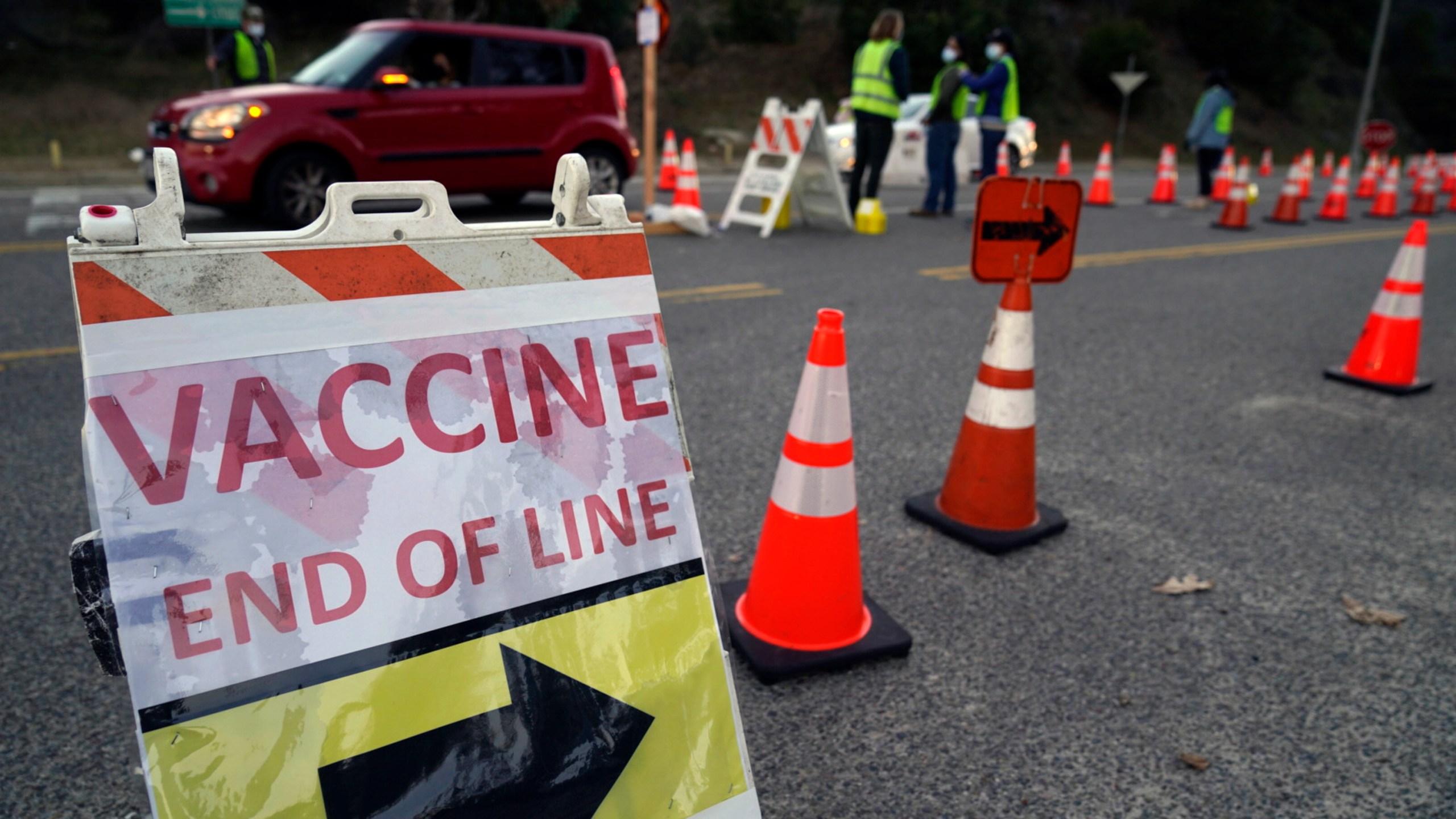 Drivers with a vaccine appointment enter a mega COVID-19 vaccination site set up in the parking lot of Dodger Stadium in Los Angeles Saturday, Jan. 30, 2021. (AP Photo/Damian Dovarganes)