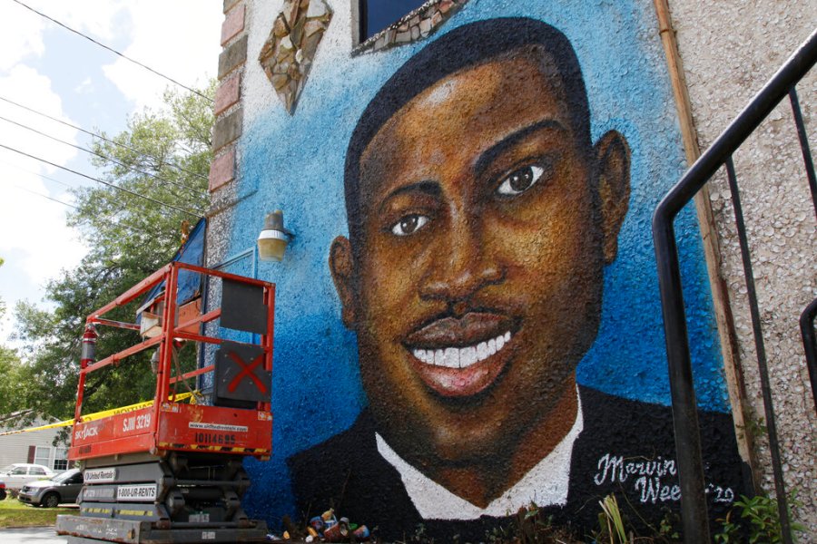 In this May 17, 2020, photo, a recently painted mural of Ahmaud Arbery is on display in Brunswick, Ga., where the 25-year-old man was shot and killed in February. It was painted by Miami artist Marvin Weeks. (AP Photo/Sarah Blake Morgan)