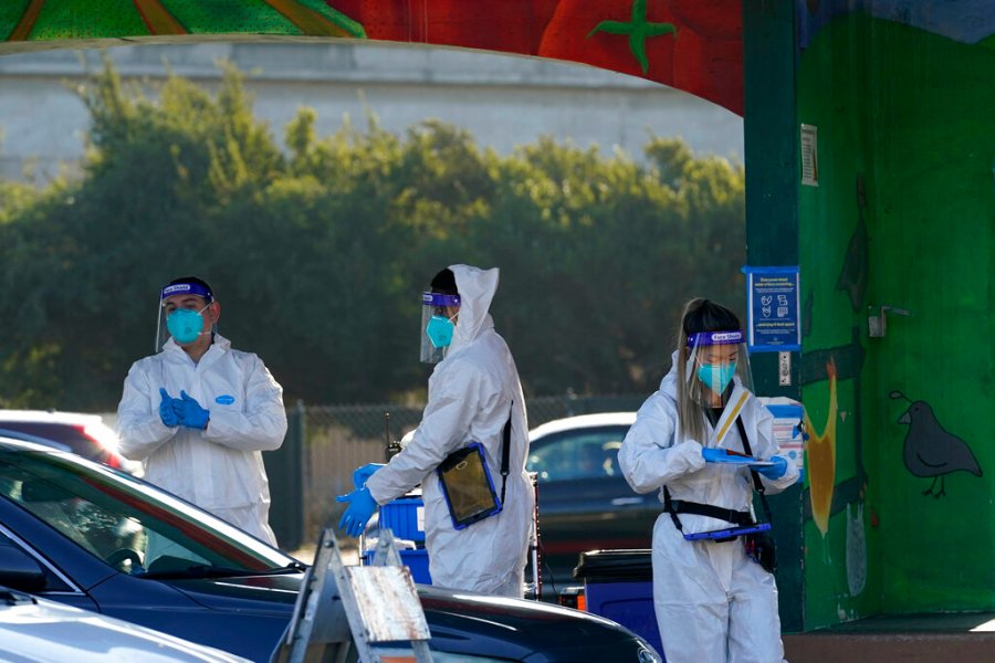 Health care workers prepare coronavirus tests at the CityTestSF at Alemany Farmer's Market in San Francisco , Dec. 22, 2020. (AP Photo/Jeff Chiu)