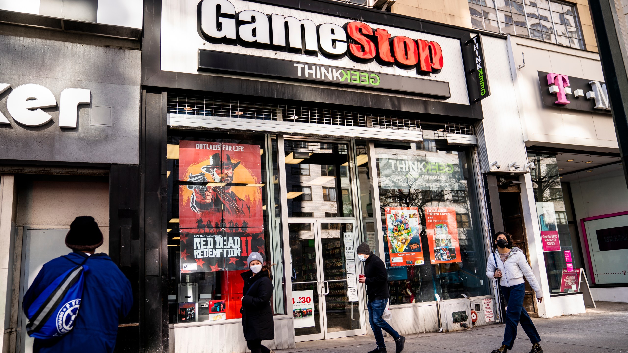 Pedestrians pass a GameStop store on 14th Street at Union Square in Manhattan on Jan. 28, 2021. (John Minchillo / Associated Press)