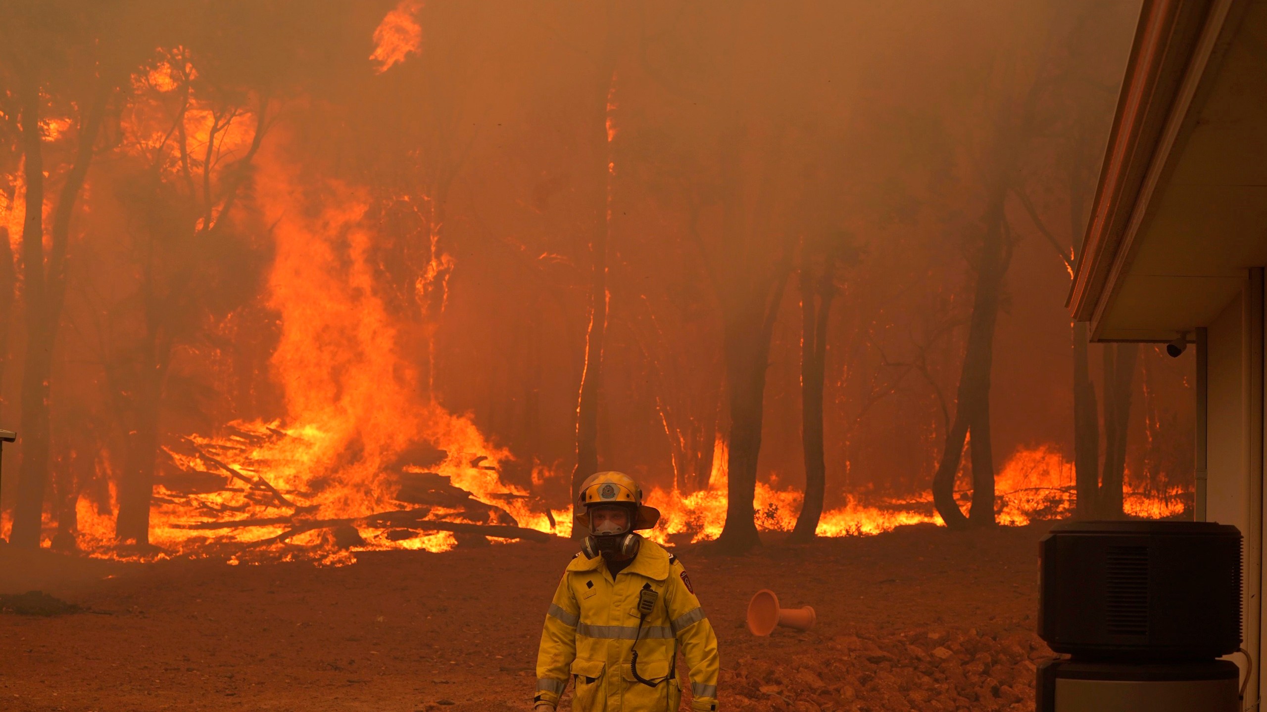 In this photo provided by Department of Fire and Emergency Services, a firefighter attends a fire near Wooroloo, northeast of Perth, Australia, on Feb. 2, 2021. (Evan Collis/DFES via Associated Press)