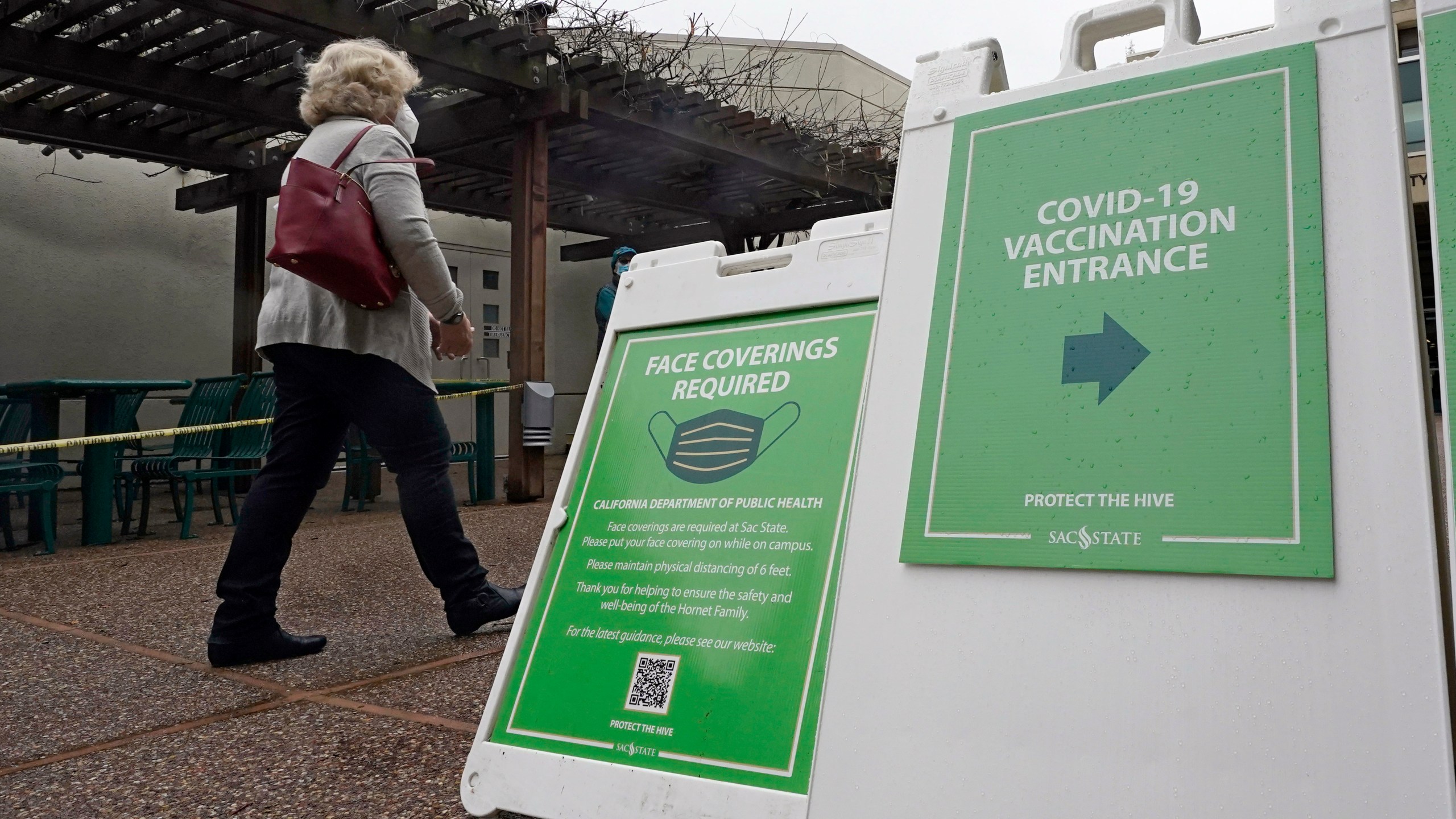 Signs direct people to a recently opened COVID-19 vaccination center at CSU Sacramento on Feb. 2, 2021. (Rich Pedroncelli / Associated Press)