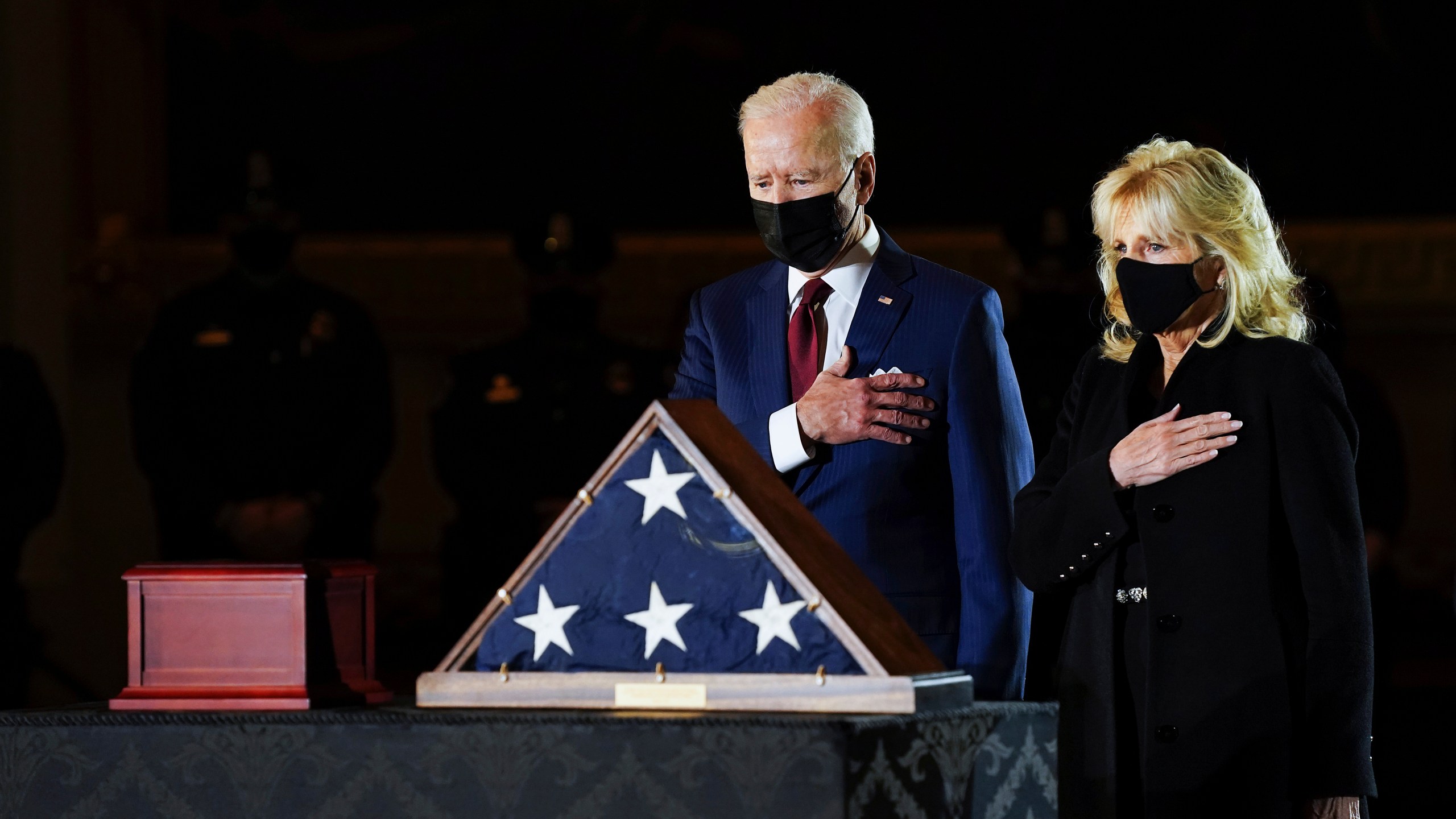 President Joe Biden and first lady Jill Biden pay their respects to the late U.S. Capitol Police Officer Brian Sicknick as an urn with his cremated remains lies in honor on a black-draped table at center of Capitol Rotunda on Feb. 2, 2021. (Erin Schaff / The New York Times via Associated Press)