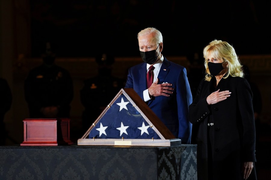 President Joe Biden and first lady Jill Biden pay their respects to the late U.S. Capitol Police Officer Brian Sicknick as an urn with his cremated remains lies in honor on a black-draped table at center of Capitol Rotunda on Feb. 2, 2021. (Erin Schaff / The New York Times via Associated Press)